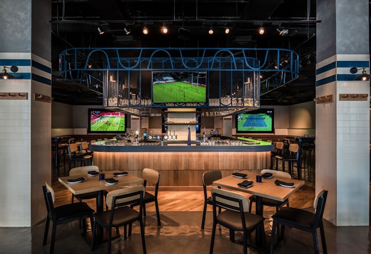 Immerse yourself in the nostalgic ambience of vintage clubhouses at Bridgewater Tavern designed by Studio Königshausen. The sports bar captures the essence of architectural finesse, contemporary design, and warm hospitality in the heart of Dubai.